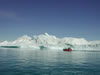 Her er en af turistbådene fra Ilulissat foran et isbjerg.
